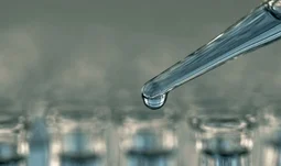 a pipette with blue liquid 