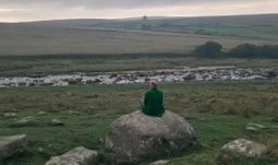 a man on a rock in the wilderness in the UK 
