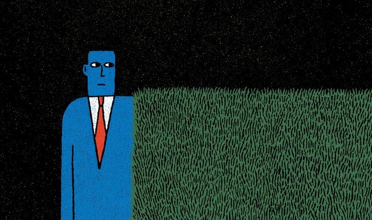 man next to hedge