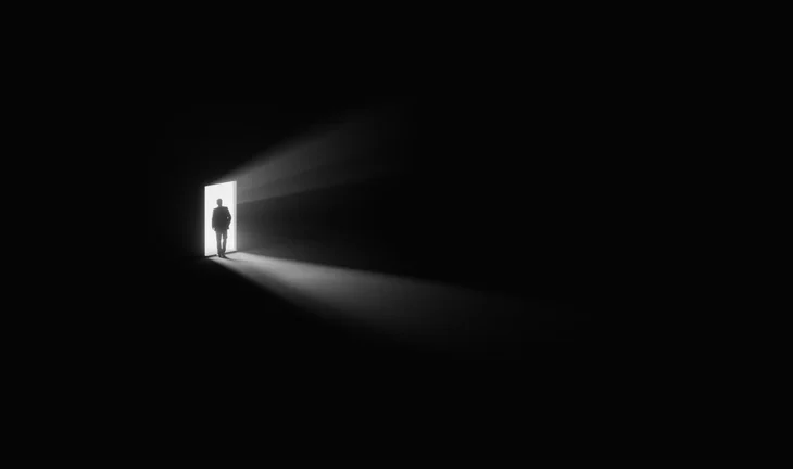 a man walking out a door