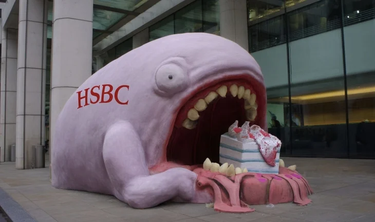a pink blob with hsbc written on it eating cakes