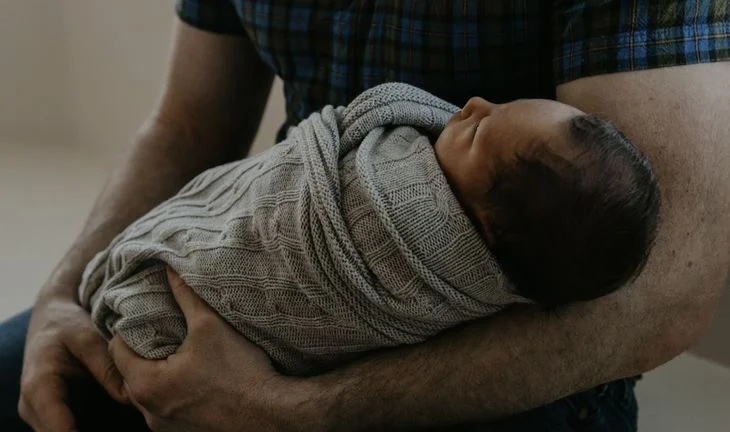 father holding a baby