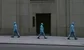 blue men outside a bank 