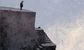 a small man on some ledges 